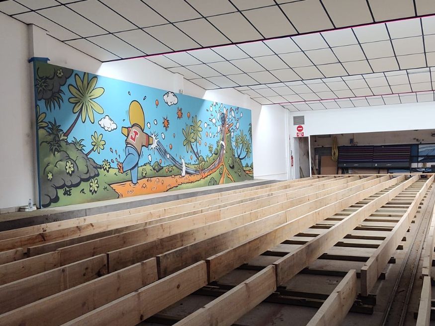 Bowling alley builders rebuilding 12 lane foundations with new wood framing during renovation project on Réunion Island
