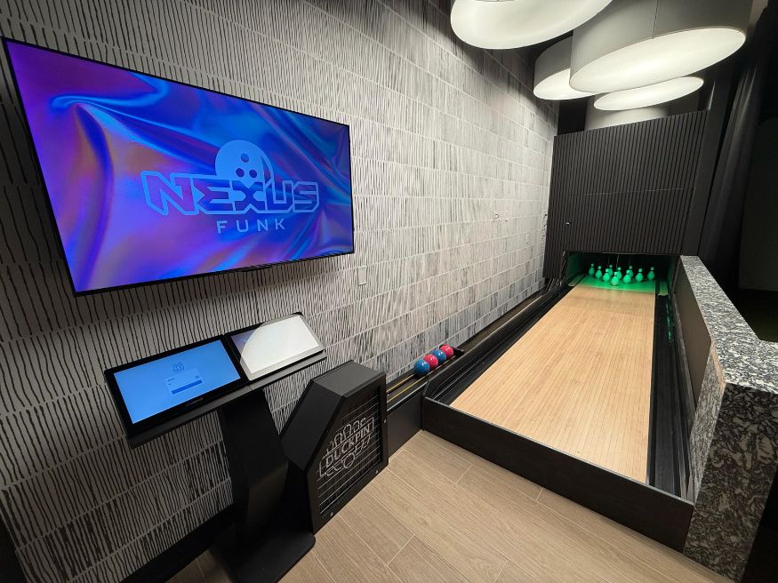 Bowling alley builders install a custom duckpin lane with Nexus scoring on the 10th floor of a Charlotte high-rise