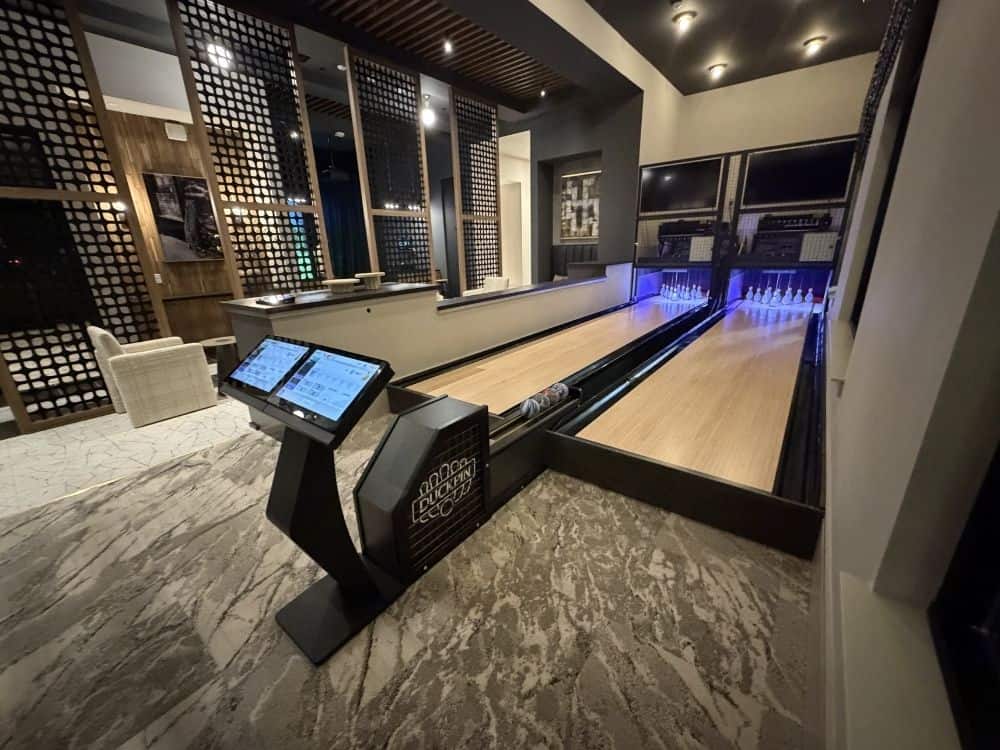 Modern duckpin bowling alley inside luxury apartment community with two lanes and touchscreen scoring system