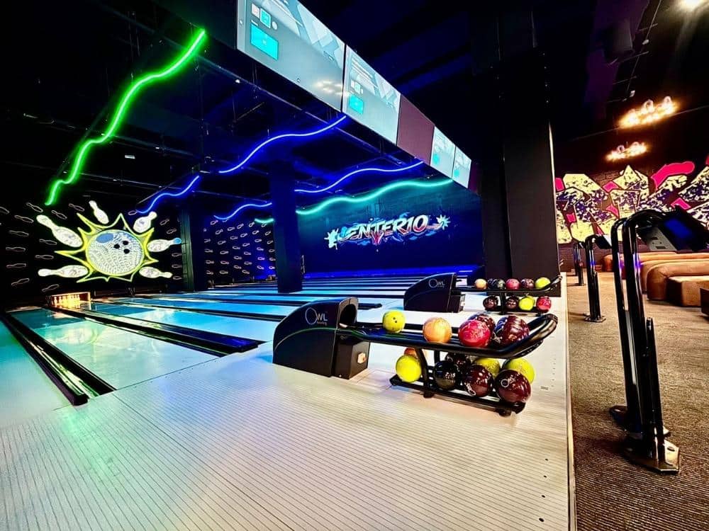 Modern ten pin bowling lanes at ENTER10 Abu Dhabi featuring neon lighting, arcade-style atmosphere, and family-friendly entertainment space