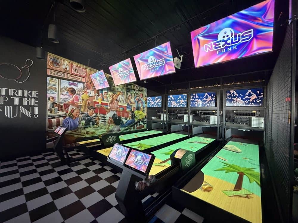 Modern bowling alley equipment at Tastyland Monroeville featuring four duckpin bowling lanes, Nexus scoring, and on-lane projection technology.
