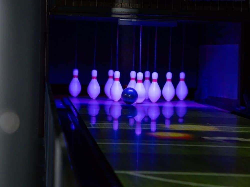 Bowling installation featuring Funk duckpin lanes with interactive on-lane projection, string pinsetter technology, and illuminated pins at RecRoom in Downtown Lakeland.